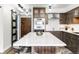 Kitchen with a large island, white countertops, and custom cabinetry at 1551 Larimer St # 1405, Denver, CO 80202