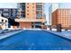 Rooftop pool covered with a tarp, surrounded by lounge chairs and cityscape views at 1551 Larimer St # 1405, Denver, CO 80202