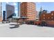 Rooftop deck area with BBQ grills and seating, surrounded by downtown buildings at 1551 Larimer St # 1405, Denver, CO 80202