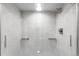 A luxurious walk-in shower with gray marble tiling and recessed shelving provides a spa-like experience at 1551 Larimer St # 1405, Denver, CO 80202