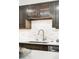 Close-up of a kitchen sink with stylish fixtures and a marble tile backsplash at 1551 Larimer St # 1405, Denver, CO 80202