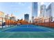 Outdoor tennis court surrounded by cityscape views and brick walls at 1551 Larimer St # 1405, Denver, CO 80202