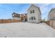 Exterior view of back of two-story home and pergola with snow covered back yard at 13353 Amber Sky St, Parker, CO 80134