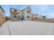 Back exterior of home featuring snow-covered yard, outdoor kitchen and dining area at 13353 Amber Sky St, Parker, CO 80134