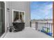 Back porch featuring grill, small childs bicycle, and view of neighborhood in snowy conditions at 13353 Amber Sky St, Parker, CO 80134