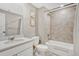 Modern bathroom with a shower-tub combination, neutral tile, and a clean, white vanity at 13353 Amber Sky St, Parker, CO 80134