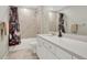 Charming bathroom with a tiled shower and a vanity featuring a white countertop at 13353 Amber Sky St, Parker, CO 80134