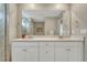 Bright bathroom featuring a double vanity with quartz countertop at 13353 Amber Sky St, Parker, CO 80134