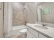 Bathroom features a shower over tub, neutral tile, and a bright white vanity at 13353 Amber Sky St, Parker, CO 80134