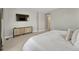 Neutral bedroom with light carpet features entertainment center and TV at 13353 Amber Sky St, Parker, CO 80134