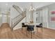 Bright dining room with wood floors, modern lighting, and staircase at 13353 Amber Sky St, Parker, CO 80134