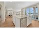 Kitchen island with stainless steel dishwasher and sink overlooks the dining room and outdoor patio at 13353 Amber Sky St, Parker, CO 80134