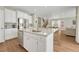 Modern kitchen island features stainless steel dishwasher and sink with an open floor plan at 13353 Amber Sky St, Parker, CO 80134