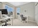 Bright home office features neutral walls, carpeted floor, and two large windows for natural light at 13353 Amber Sky St, Parker, CO 80134