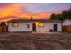 View of the backyard and exterior showcasing the freshly painted white exterior and new fencing at 5304 Granby St, Denver, CO 80239