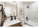 Charming bathroom offers bathtub and shower, sleek fixtures, and updated vanity at 5304 Granby St, Denver, CO 80239