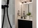 Nicely updated bathroom featuring stylish vanity and sleek black fixtures at 5304 Granby St, Denver, CO 80239