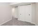This is a bedroom with carpet and white walls with matching trim and a closet at 5304 Granby St, Denver, CO 80239
