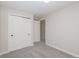 This is a bedroom with carpet and white walls with matching trim and a closet at 5304 Granby St, Denver, CO 80239