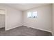 Neutral bedroom features large window, closet, and comfortable carpet at 5304 Granby St, Denver, CO 80239