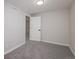 This is a bedroom with carpet and white walls with matching trim and a white door at 5304 Granby St, Denver, CO 80239