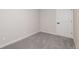 This is a bedroom with carpet and white walls with matching trim and a white door at 5304 Granby St, Denver, CO 80239