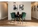 Dining area featuring wooden table with seating for four with modern art at 5304 Granby St, Denver, CO 80239