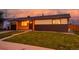 Charming single-story home featuring a combination of wood and brick exterior, complemented by a well-manicured lawn at 5304 Granby St, Denver, CO 80239