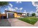Charming single-story home featuring a combination of wood and brick exterior, complemented by a well-manicured lawn at 5304 Granby St, Denver, CO 80239