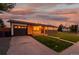 Charming single-story home featuring a combination of wood and brick exterior, complemented by a well-manicured lawn at 5304 Granby St, Denver, CO 80239