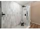 Modern bathroom shower features black fixtures, patterned tile, and a small stool at 5304 Granby St, Denver, CO 80239