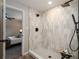 Modern shower boasts sleek, updated fixtures and tasteful neutral tiling at 5304 Granby St, Denver, CO 80239