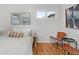 Bright bedroom with modern decor, hardwood floors, and natural light from a large window at 3377 N Krameria St, Denver, CO 80207