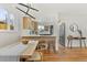 Bright dining area with modern lighting and a view into the updated kitchen at 3377 N Krameria St, Denver, CO 80207