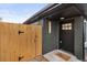 Stylish front entrance features black brick, a wooden gate, and a modern front door at 3377 N Krameria St, Denver, CO 80207