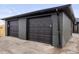 Spacious two car garage with dark gray doors and a modern brick exterior and drainage at 3377 N Krameria St, Denver, CO 80207