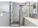 Bathroom with sleek gray tiling, a glass-enclosed shower, and modern fixtures at 16212 E Geddes Ln # 11, Aurora, CO 80016