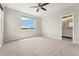 Bedroom featuring a ceiling fan, a view of a bathroom, and light-filled windows at 16212 E Geddes Ln # 11, Aurora, CO 80016