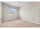 Bright bedroom features neutral walls and carpet with a large window at 16212 E Geddes Ln # 11, Aurora, CO 80016