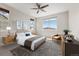 Bright bedroom with neutral walls, ceiling fan, carpet and tastefully staged with modern furniture at 16212 E Geddes Ln # 11, Aurora, CO 80016