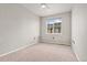 Bright bedroom features neutral walls and carpet with a large window at 16212 E Geddes Ln # 11, Aurora, CO 80016