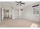 Bedroom with neutral walls, carpet, ceiling fan, built-in shelves and hallway leading to other rooms at 16212 E Geddes Ln # 11, Aurora, CO 80016