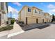 Townhome exterior features garages, neutral siding and brick facade at 16212 E Geddes Ln # 11, Aurora, CO 80016