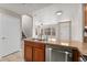 Functional kitchen with a pass-through to the living area and stair access, designed for easy living at 16212 E Geddes Ln # 11, Aurora, CO 80016