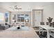 Stylishly furnished living room with modern furniture, a ceiling fan, and plenty of natural light from large windows at 16212 E Geddes Ln # 11, Aurora, CO 80016