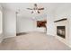 Spacious living room with fireplace, ceiling fan and seamless transition to the kitchen, perfect for modern living at 16212 E Geddes Ln # 11, Aurora, CO 80016