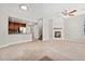Open-concept living room with a fireplace, ceiling fan, and seamless transition to the kitchen, perfect for entertaining at 16212 E Geddes Ln # 11, Aurora, CO 80016