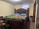 Bedroom featuring a large bed with a decorative headboard and neutral wall paint at 7488 Quivas St, Denver, CO 80221