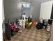 Unfinished storage area with paint buckets and household items on a checkered floor at 7488 Quivas St, Denver, CO 80221