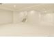 A clean, open basement features a stairway and ample lighting at 10293 E Sheri Ln, Englewood, CO 80111